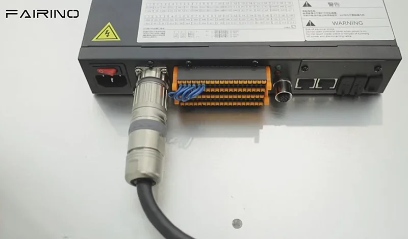 Fairino fr10 control module with cables and connectors visible, showcasing its technical design and connectivity features. Branding visible on the unit.