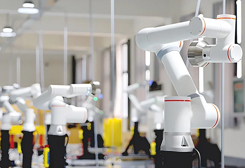 Robots in a factory use fairino fr20 arms for precise assembly, featuring white and red designs, with multiple robotic arms in a well-lit industrial setting.