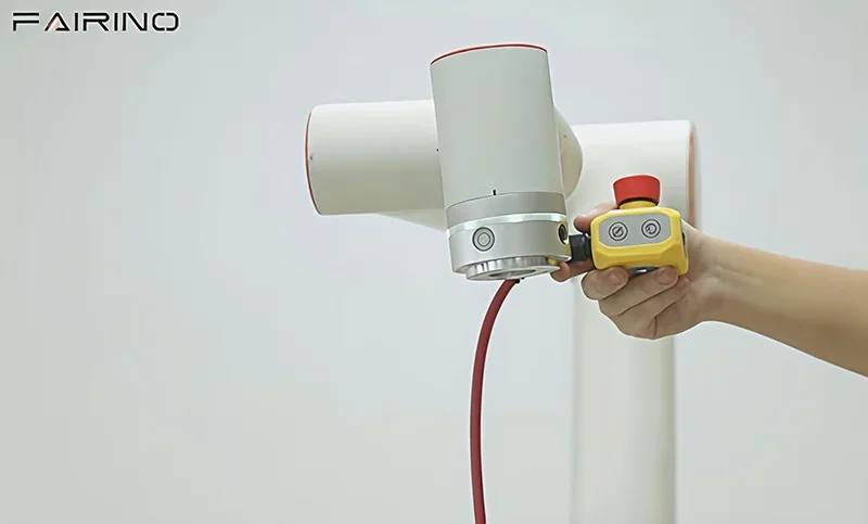 Fairino FR30 robot arm with a red and yellow control grip, sleek white design, showcased against a plain background, logo visible in the corner.