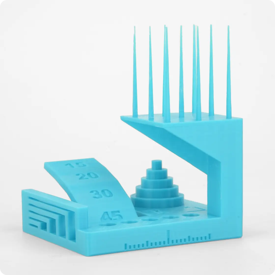 Flashforge AD5X 3D printer sample: blue geometric test print showing spikes, angles, and stairs to demonstrate precision and detail capability.