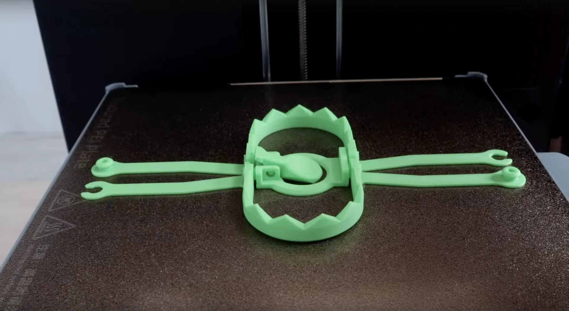 Flashforge AD5X 3D printer creating a green, circular tool on a textured platform, showcasing precision and design capabilities.