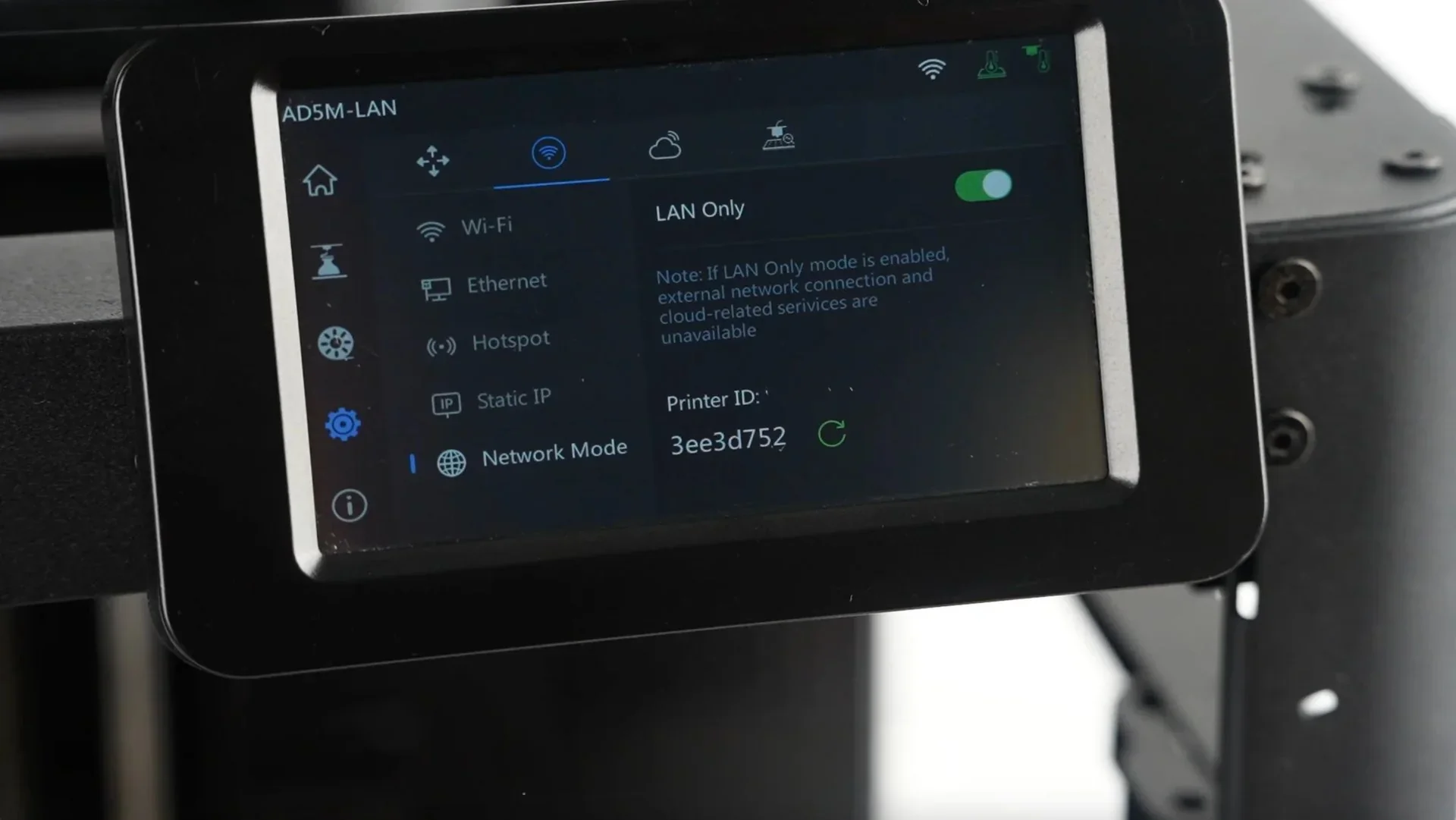 Flashforge AD5X control screen displaying LAN settings and printer ID, situated on a sleek black frame.