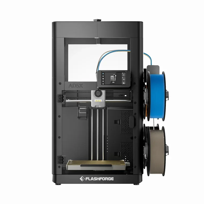 The Flashforge AD5X 3D printer showcases a sleek, black design with a prominent cubic frame housing the printing mechanism. The printer features a clear front view of its detailed interior setup, including the dual vertical rods for precision movements. Visible components include the nozzle assembly at the center, integrated with linear rails for enhanced stability and accuracy during printing. Above the nozzle, there's a touchscreen control panel displaying user interface elements for easy operation. On the right side, two spools of filament, one blue and one bronze, are mounted vertically, ready for automatic feeding into the printer. Branding is clearly displayed at the bottom with the 