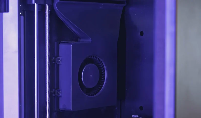 Flashforge Adventurer 5M Pro internal view showing a cooling system and linear rail, highlighting its precision engineering and advanced features.