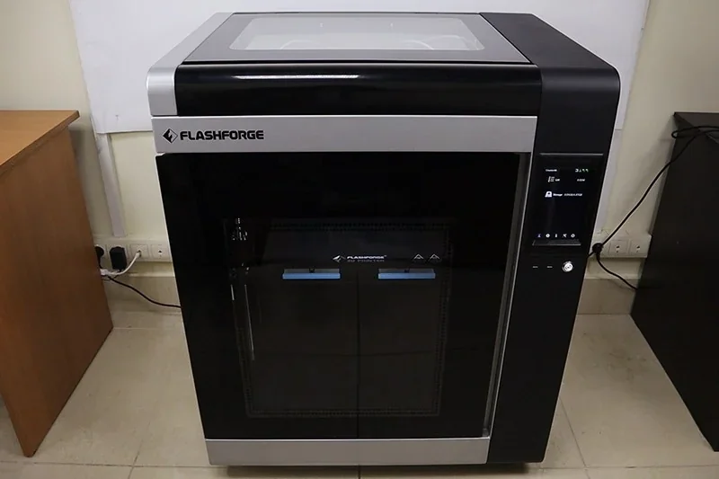 Flashforge Creator 4 3D printer with sleek black and silver design, touchscreen interface, in an office setting.