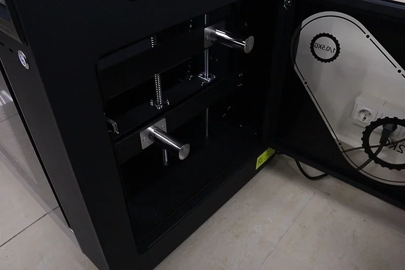 Flashforge Creator 4 interior showing metal components and gears, set in a tiled room.