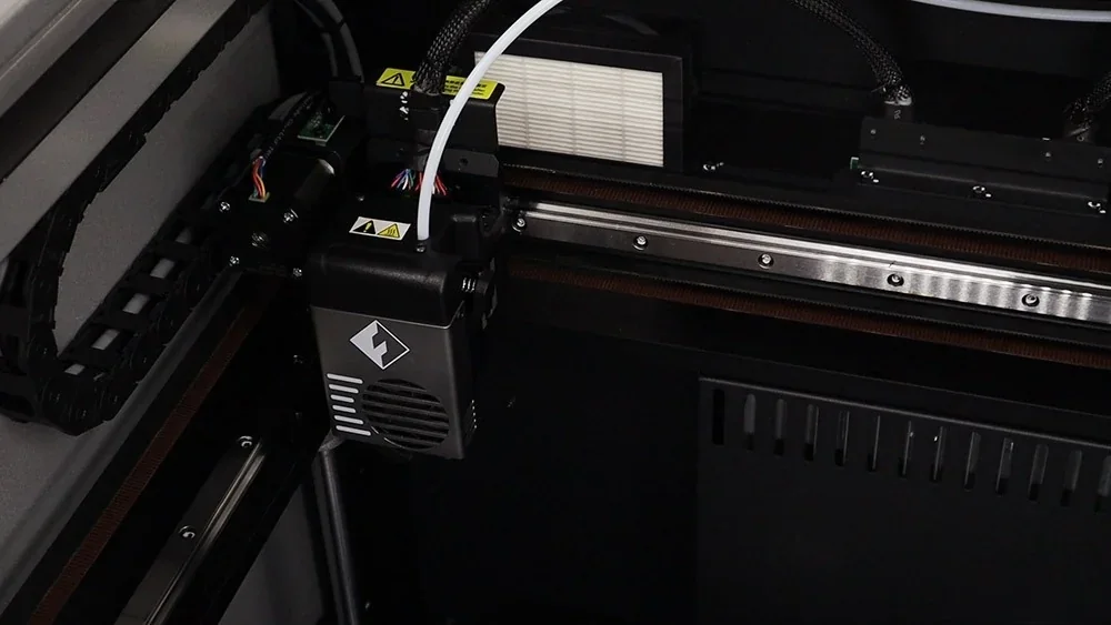 Flashforge Creator 4 3D printer close-up showing extruder and internal components, emphasizing precision engineering and design efficiency.