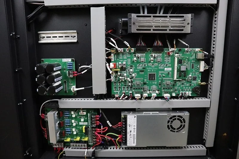Flashforge Creator 4 internal electronics showing circuit boards, wiring, and power supply unit within the 3D printer’s cabinet.