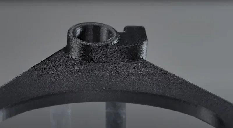 3D printed black component from Flashforge Guider 3 Ultra, showcasing sleek design and precision details on a neutral background.