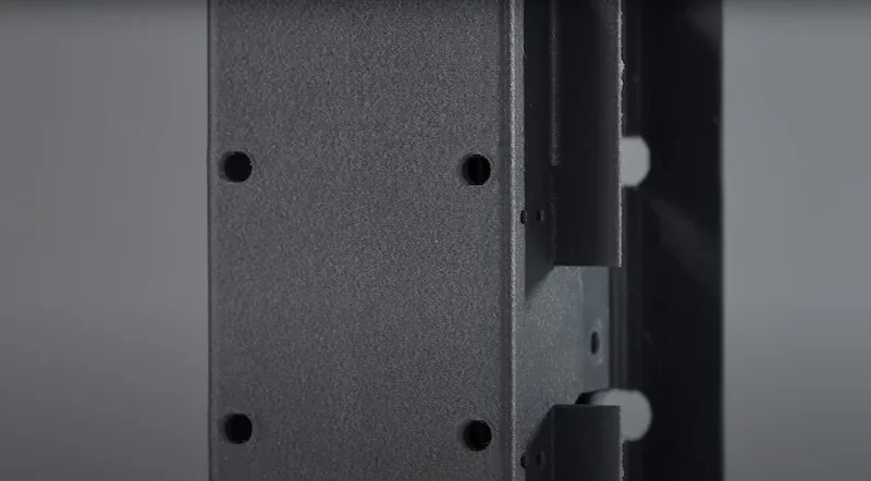 Close-up of a 3D printed component with screw holes, showcasing the precision of the Flashforge Guider 3 Ultra's capabilities.