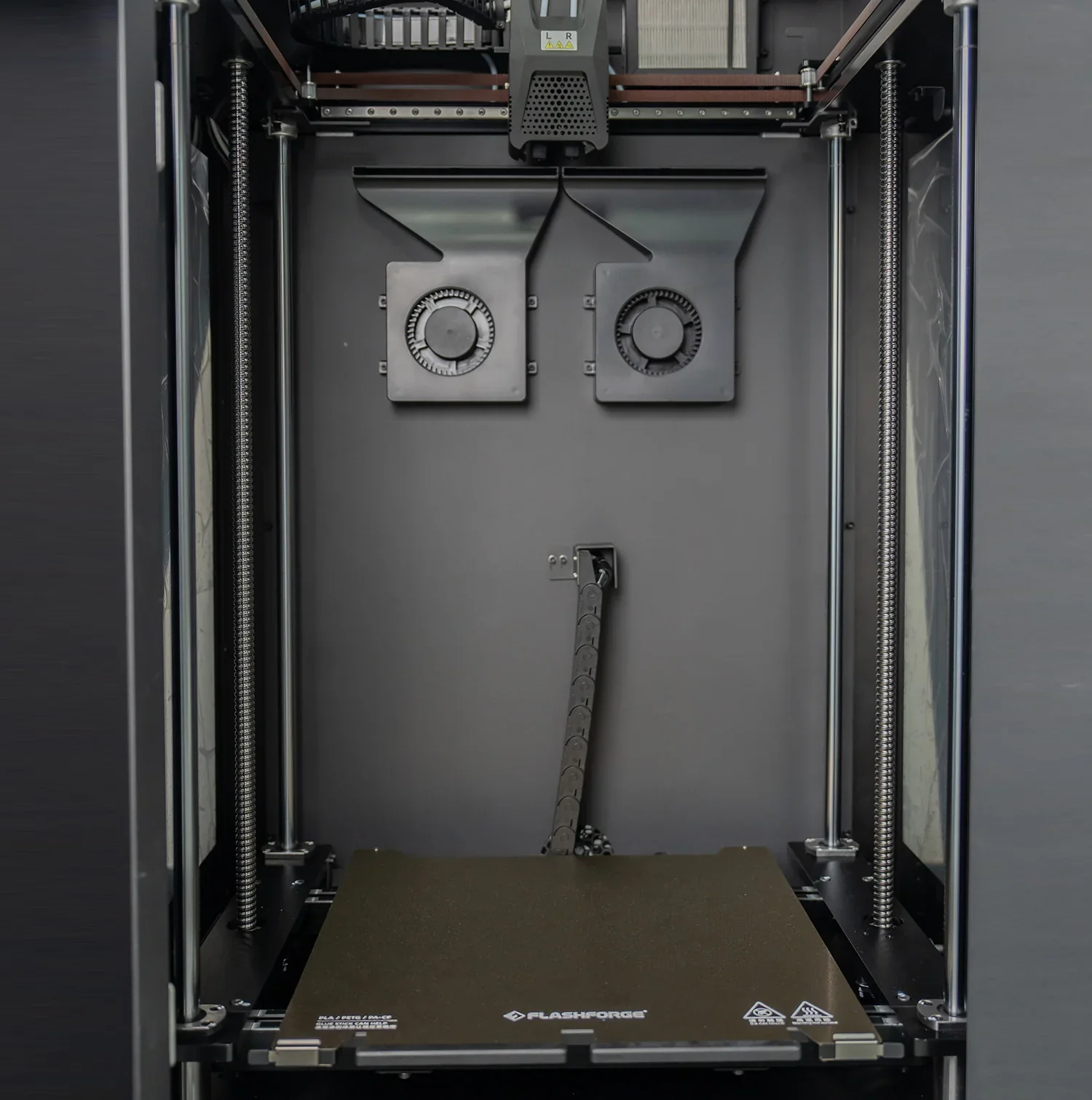Flashforge Guider 3 Ultra 3D printer interior showing dual fans, filament guide, and branded print bed.