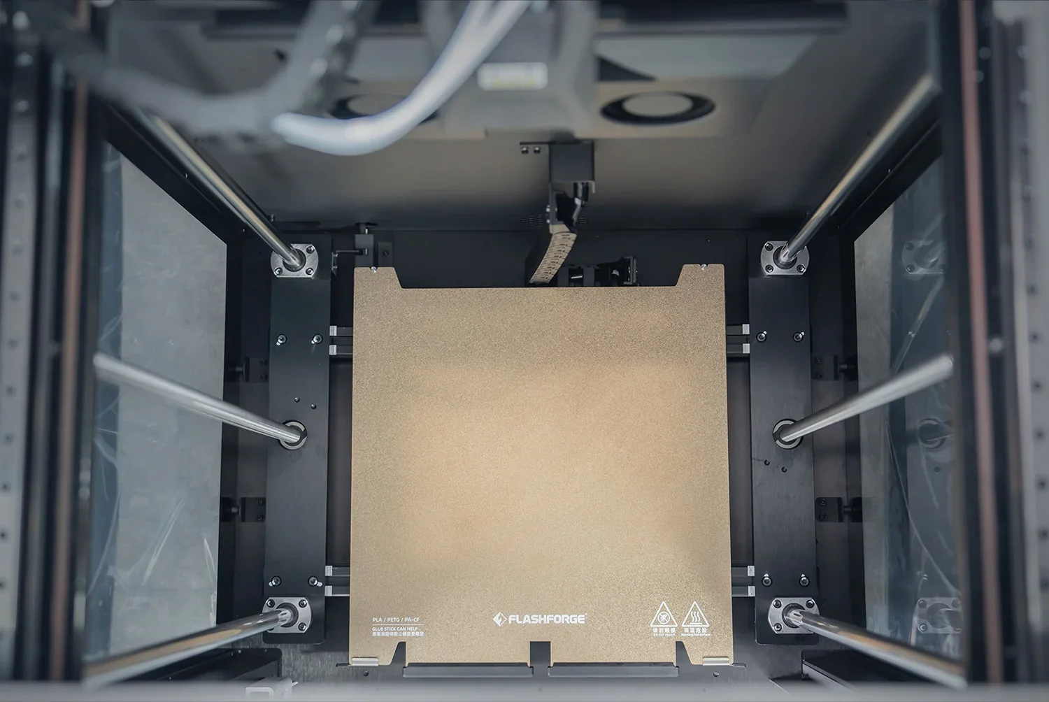 Flashforge Guider 3 Ultra 3D printer interior showing build platform and rods, branding visible.