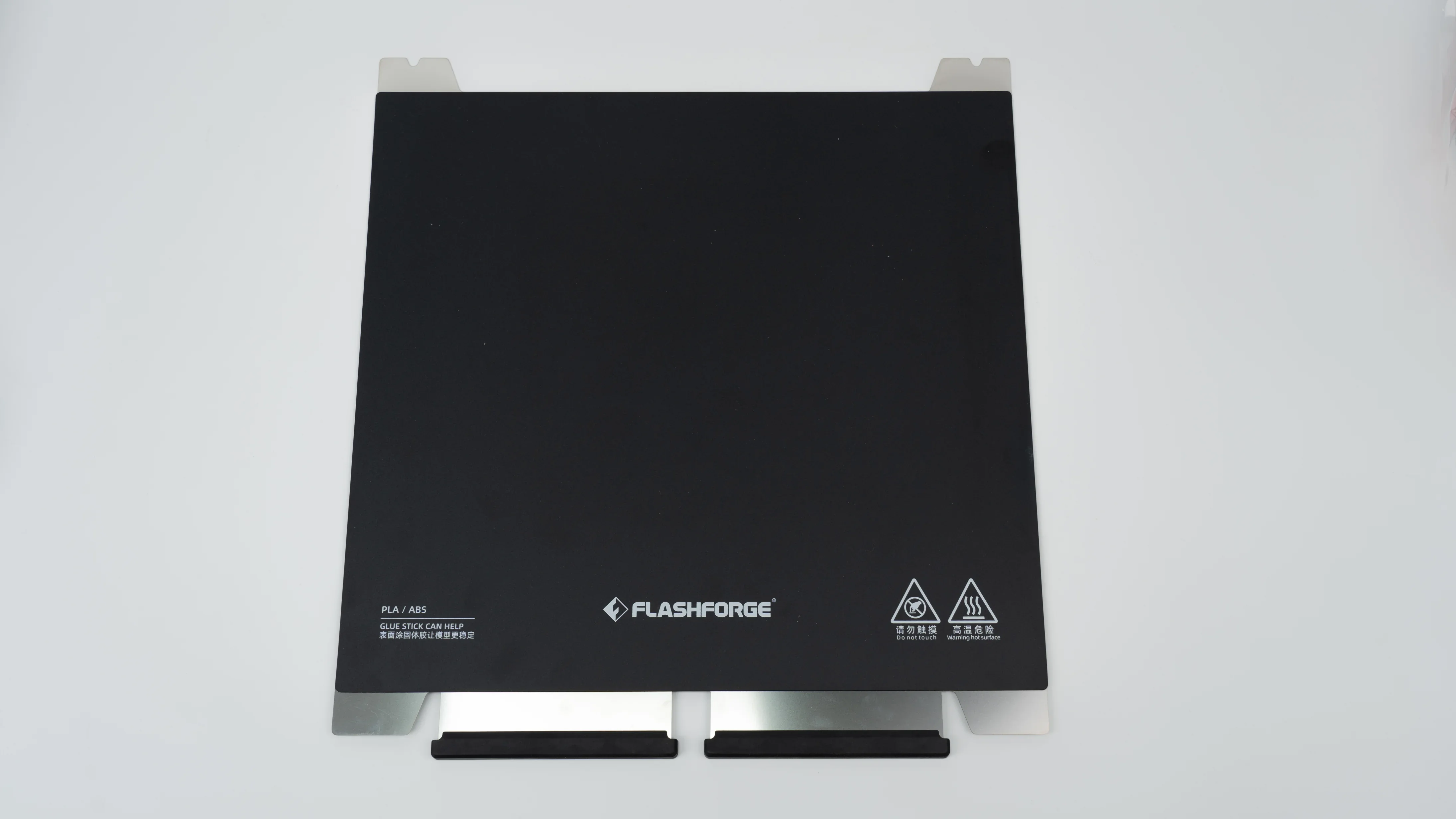 Flashforge Guider 3 Ultra black print bed with branded logo, compatible with PLA/ABS, featuring safety symbols, on a white surface.