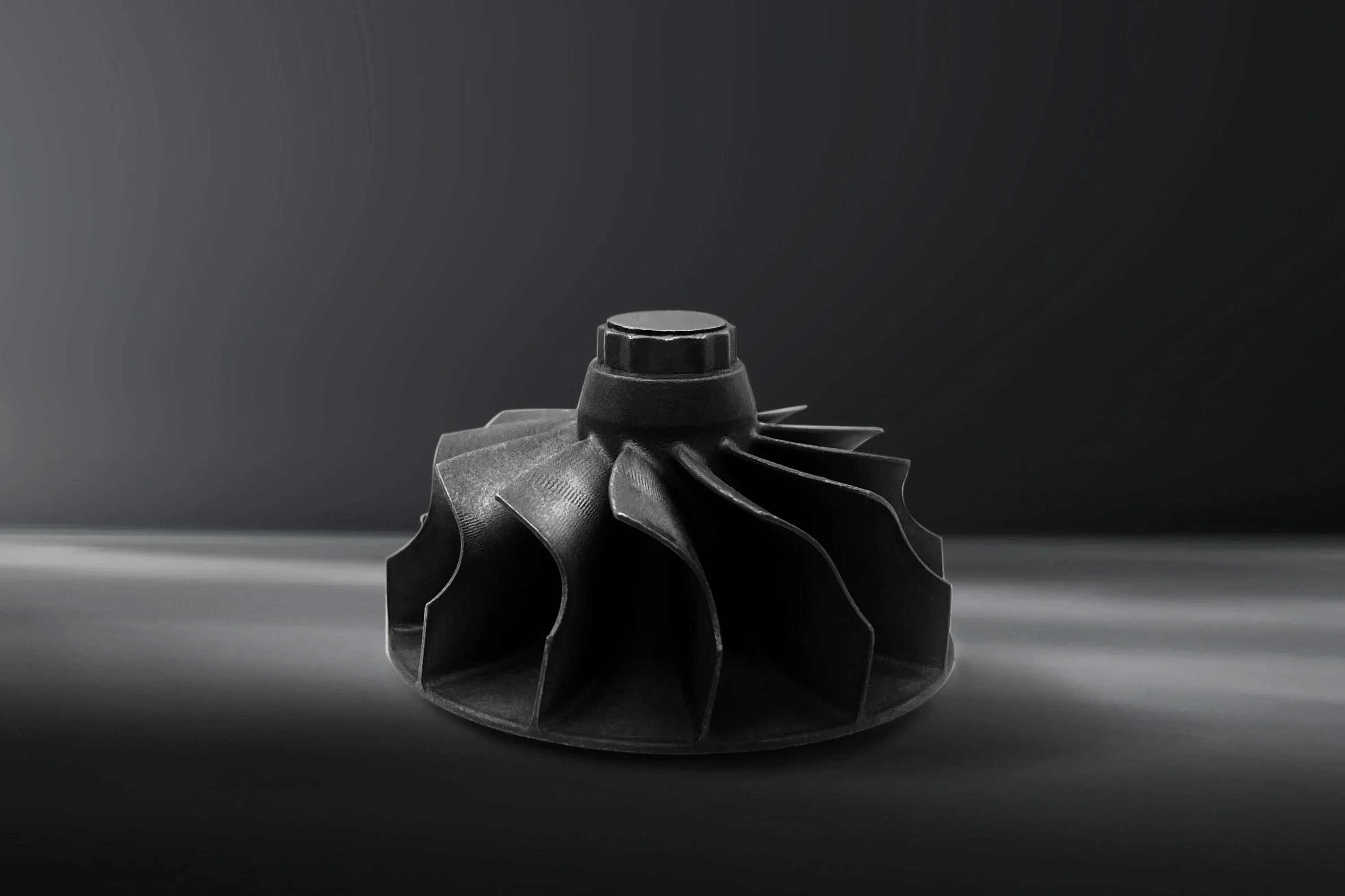 Black intricate component on dark background, created using Flashforge WaxJet 400 3D printer, showcases detailed engineering design.