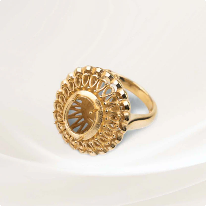 Gold ring with intricate lattice design, created by Flashforge WaxJet 400, displayed on a white surface.