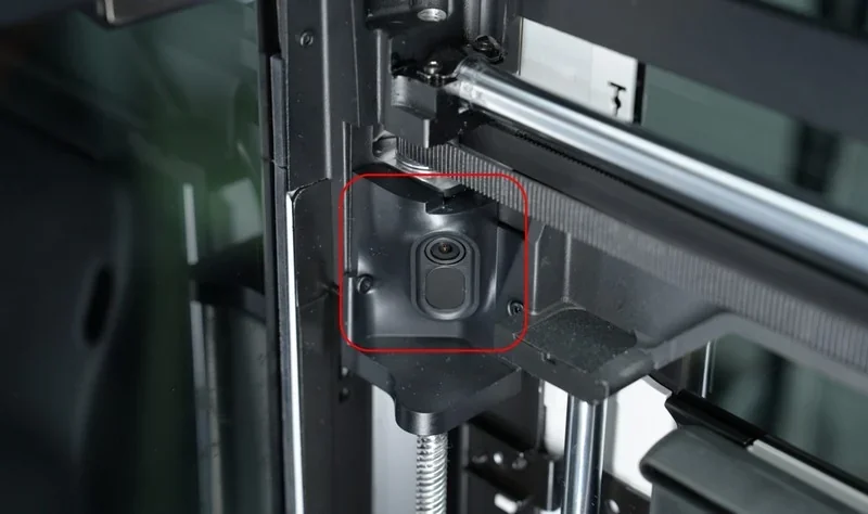 h2c Bambu 3D printer interior detail showing precise mechanical component and camera, exemplifying advanced engineering and design.