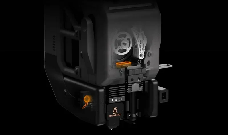 h2c Bambu 3D printer with transparent casing reveals internal mechanical parts, gears, and caution hot label, emphasizing advanced technology.