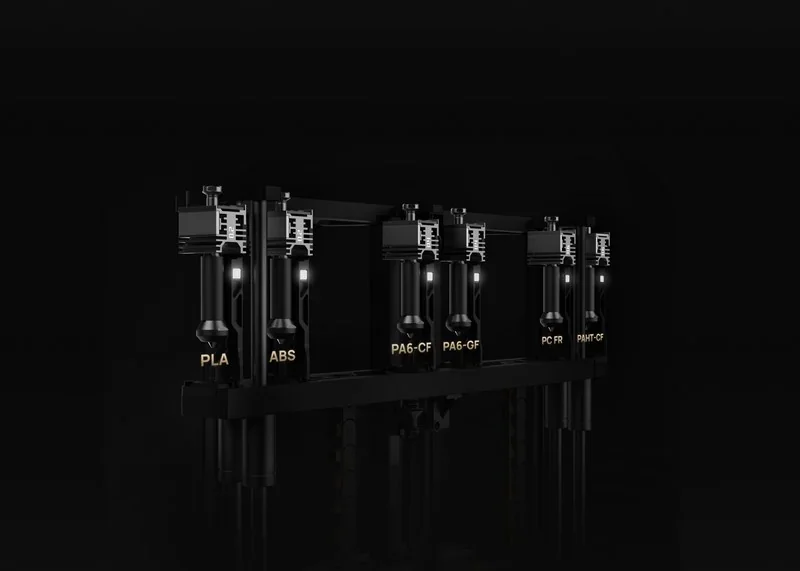h2c bambu 3D printer filament system displaying PLA, ABS, PA6-CF, PC FR types in sleek black design on a dark background.