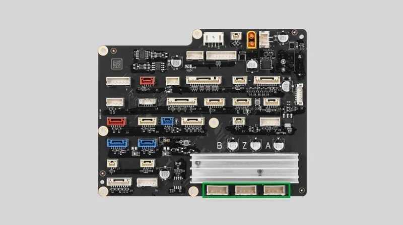 Circuit board with ports and connectors, likely part of a 3D printer setup, linked to h2c bambu, on a gray background.