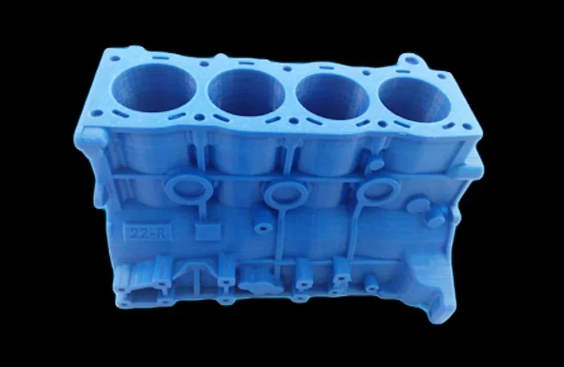 3D-printed blue engine block model created by Intamsys Funmat HT, showcasing intricate details, set against a black background.