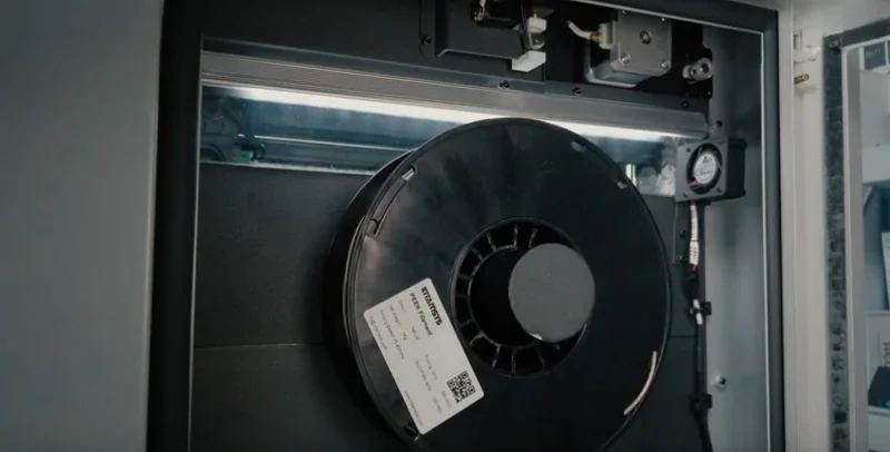 Intamsys Funmat HT 3D printer filament spool inside printer chamber, showcasing internal components and filament feed system.