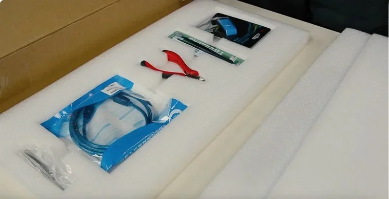 Packaging contents for Intamsys Funmat HT 3D printer include tools and cables, neatly arranged in foam slots for protection and organization.