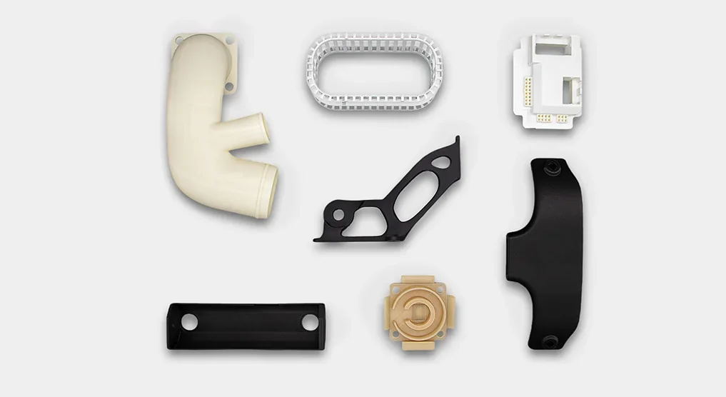 3D-printed parts including pipes, brackets, and connectors, created by the Intamsys Funmat Pro 310, showcased on a neutral background.