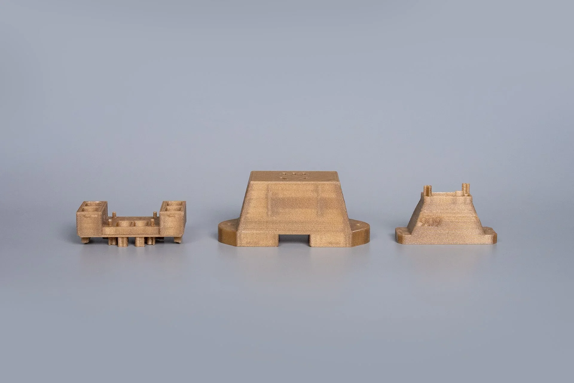 3D-printed parts by Intamsys Funmat Pro 310 arranged on a neutral background, showcasing intricate design and smooth surface finish.