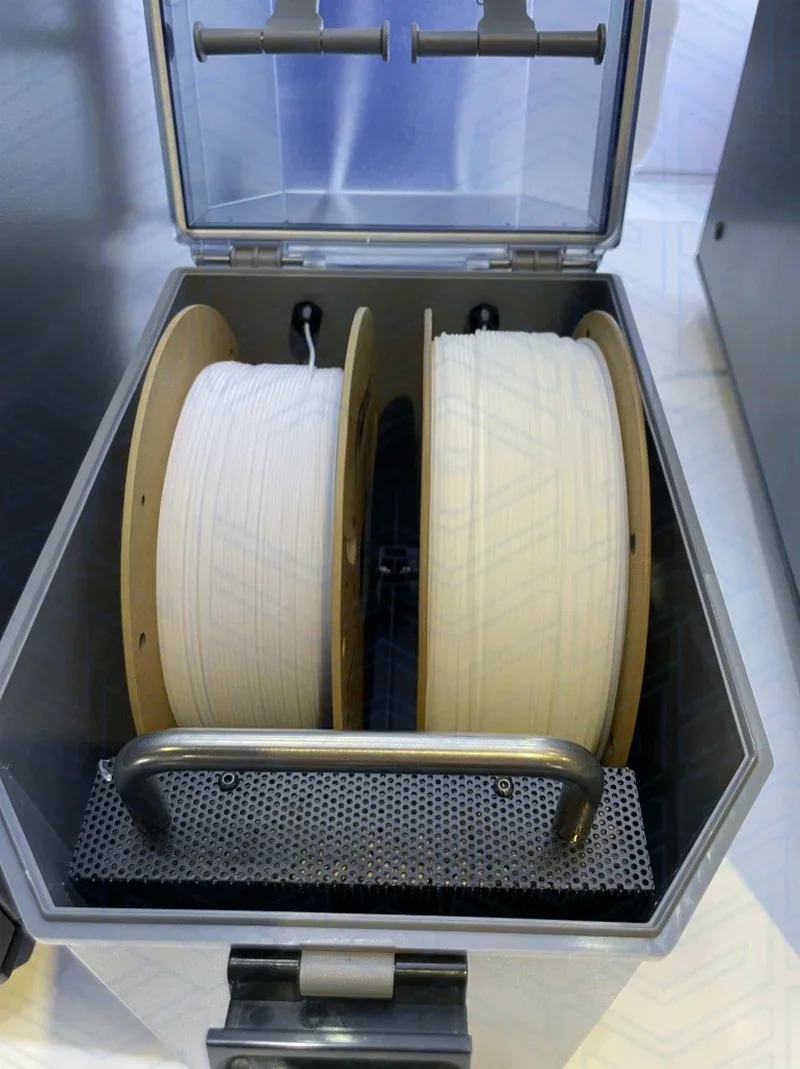 Two spools of white filament inside an intamsys funmat pro 310 3D printer.