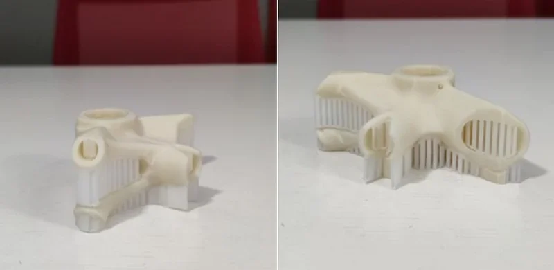 3D-printed beige parts with intricate structures on a white table, created by the Intamsys Funmat Pro 410 printer.