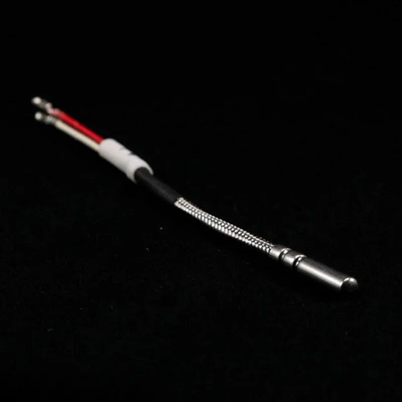 Thermocouple component from the intamsys funmat pro 410 3D printer, featuring braided metal and plastic core against a dark background.