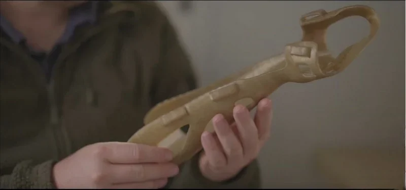 Person holding a 3D-printed part, likely a structural prototype, created using the Intamsys Funmat Pro 410.