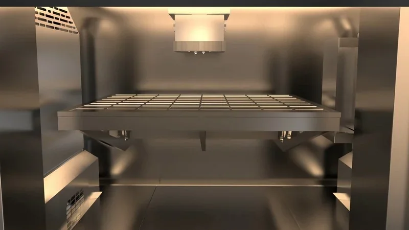 Intamsys FUNMAT Pro 610 HT 3D printer interior with metal build platform and nozzle, capable of producing high-temperature parts and samples.