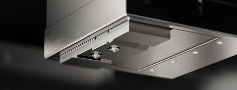 Intamsys Funmat Pro 610 HT extruder close-up with dual nozzles, sleek metal design, precision parts, showcasing 3D printing technology.