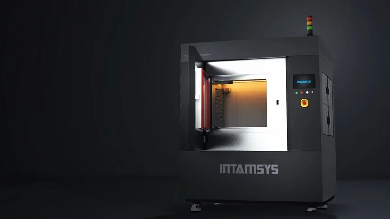 Intamsys Funmat Pro 610 HT 3D printer with open chamber showcasing interior lighting, sleek design, and displayed branding in a dark setting.