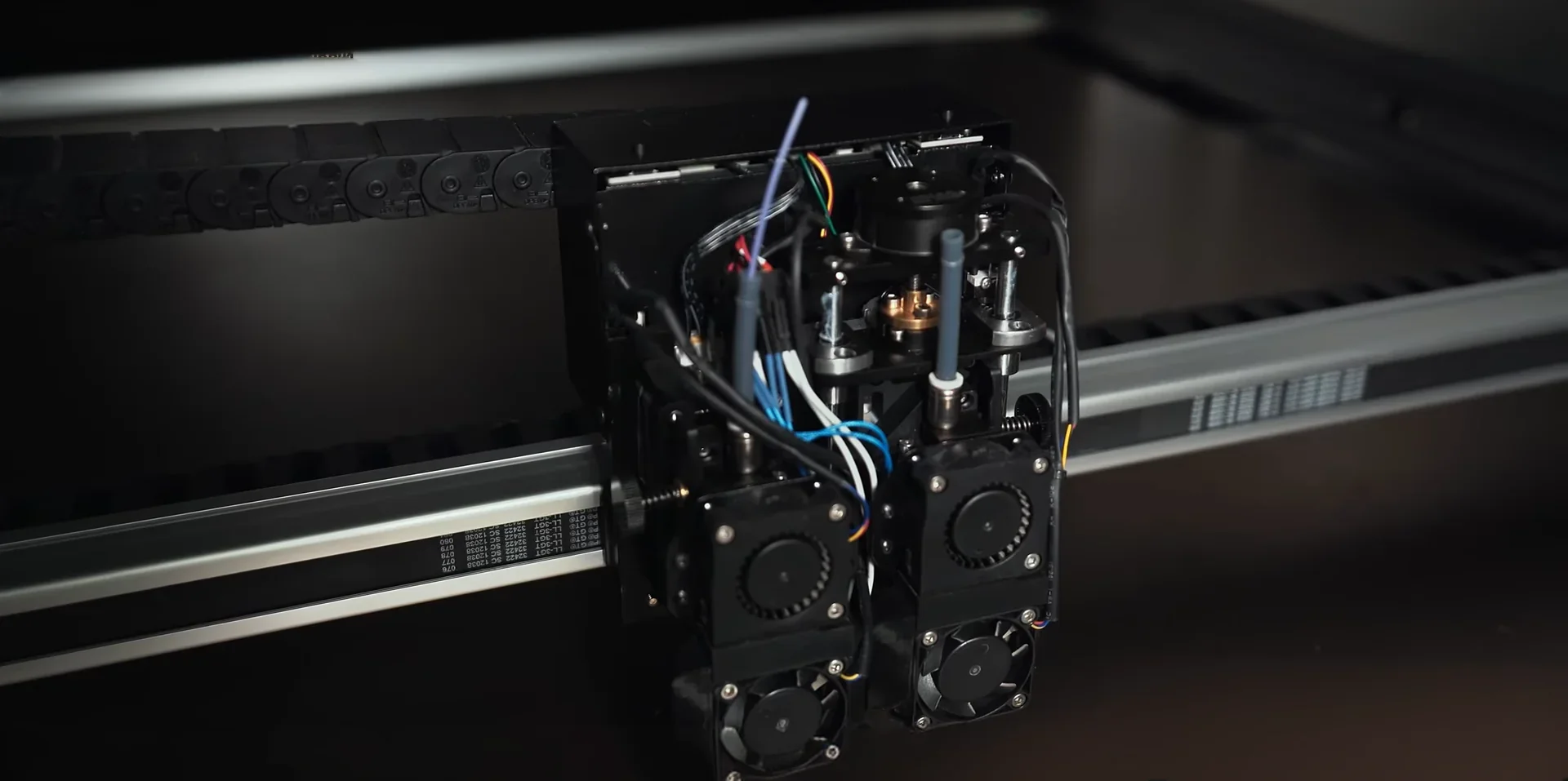 Mingda MD-1000D 3D printer component with exposed wiring and dual cooling fans, highlighting intricate technical design in a workshop setting.