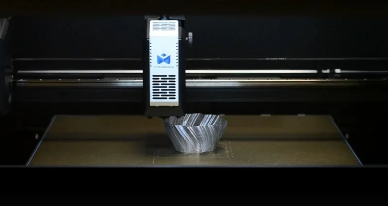 Mingda MD-400D 3D printer creating a detailed, ridged metallic part with visible branding in a dark setting.