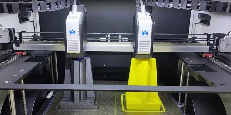 Mingda MD-400D 3D printer with dual extruders displaying gray and yellow printed objects, featuring branding and mechanical components in a workshop setting.