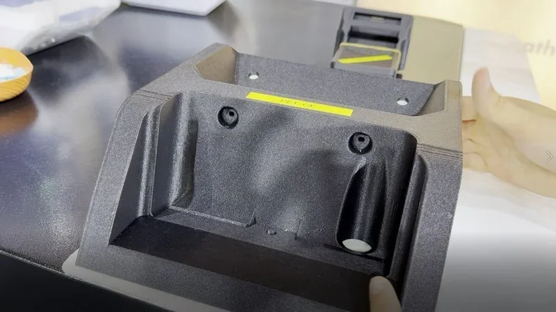 Mingda MD-400D 3D printed component displayed on a tabletop, showcasing detailed design and texture, with hands holding the part.