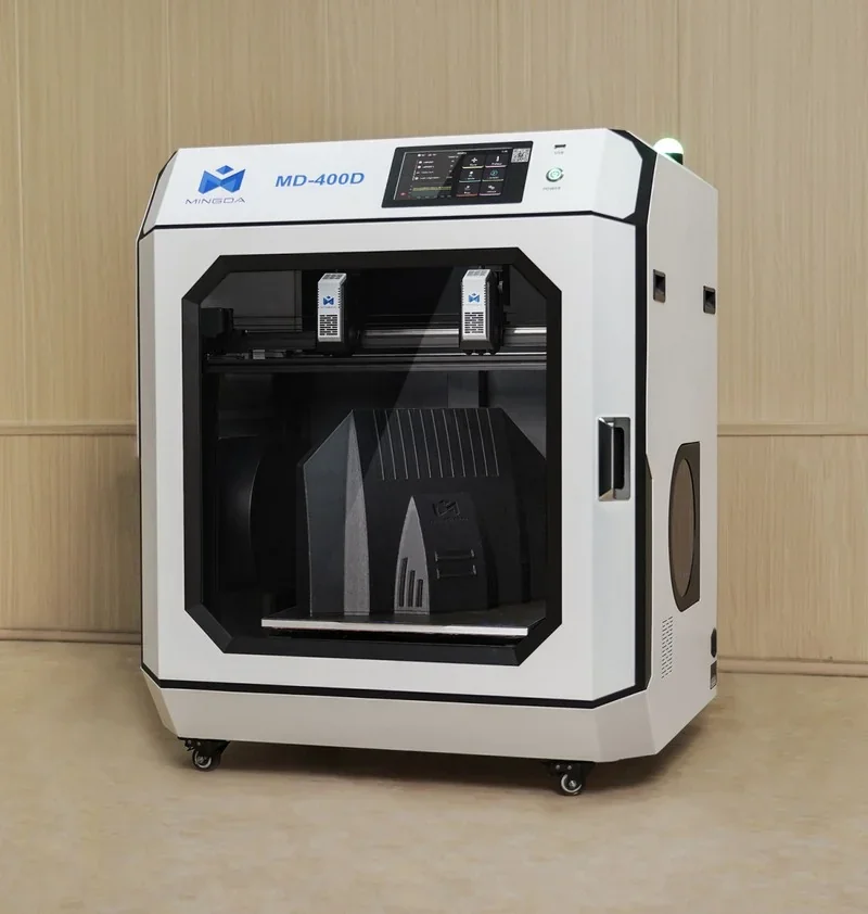 Mingda MD-400D 3D printer in a room, showcasing detailed printed parts inside, with visible controls and branding on its compact exterior design.