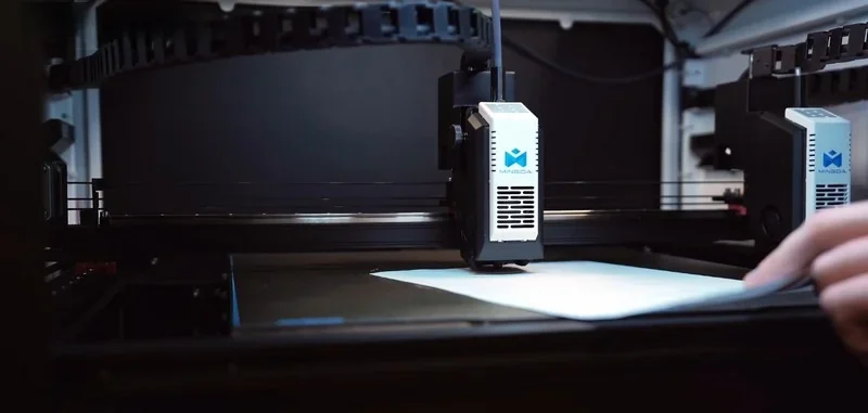 Mingda MD-400D 3D printer in action, with a filament-loaded nozzle printing on a flat surface, showcasing precision and advanced technology.