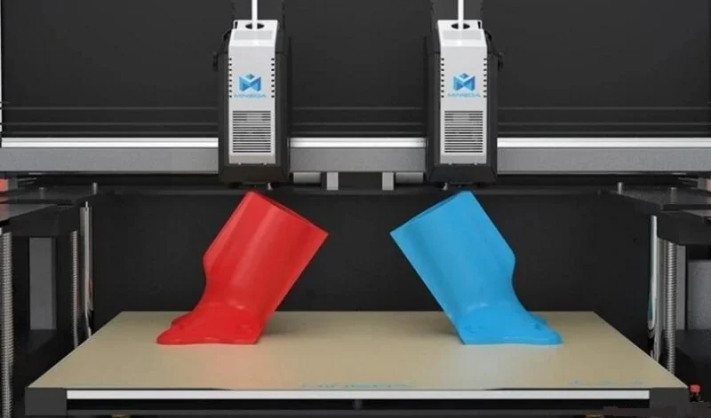 Dual-extruder 3D printer Mingda MD-400D printing red and blue objects on a flat surface, showcasing its precision and capability in creating complex models.