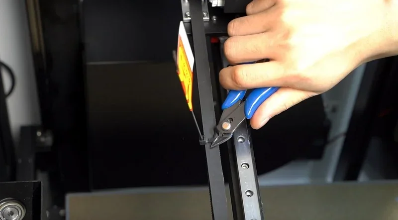 Hand using pliers on Mingda MD-400D 3D printer rail, showcasing maintenance or setup procedure.