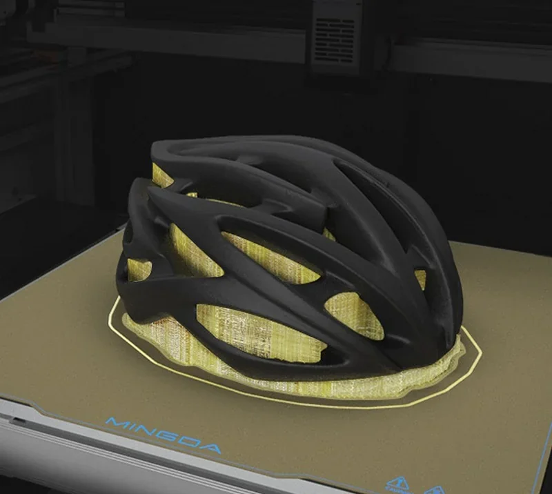 Mingda MD-400D 3D printer showcasing a black bike helmet model with yellow support structures on its print bed.