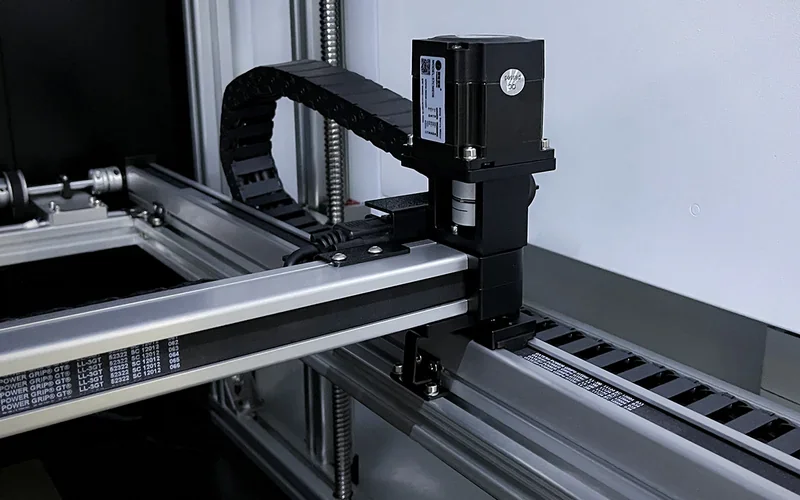 Mingda MD-600D 3D printer close-up showing linear rails and motor components in a sleek industrial setting.