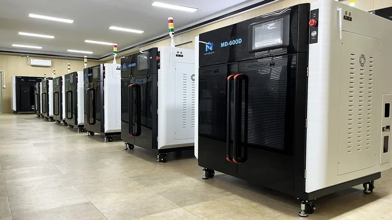 Row of Mingda MD-600D 3D printers in a spacious, well-lit room with visible branding and modern design elements, illustrating production capacity.