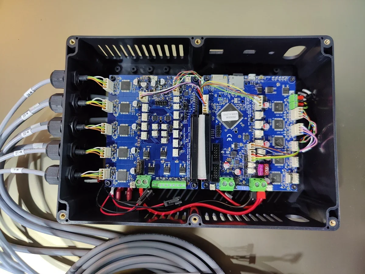 Modix Big 60 3D printer electronics setup showing wired circuit board with labeled cables and components in a black enclosure.
