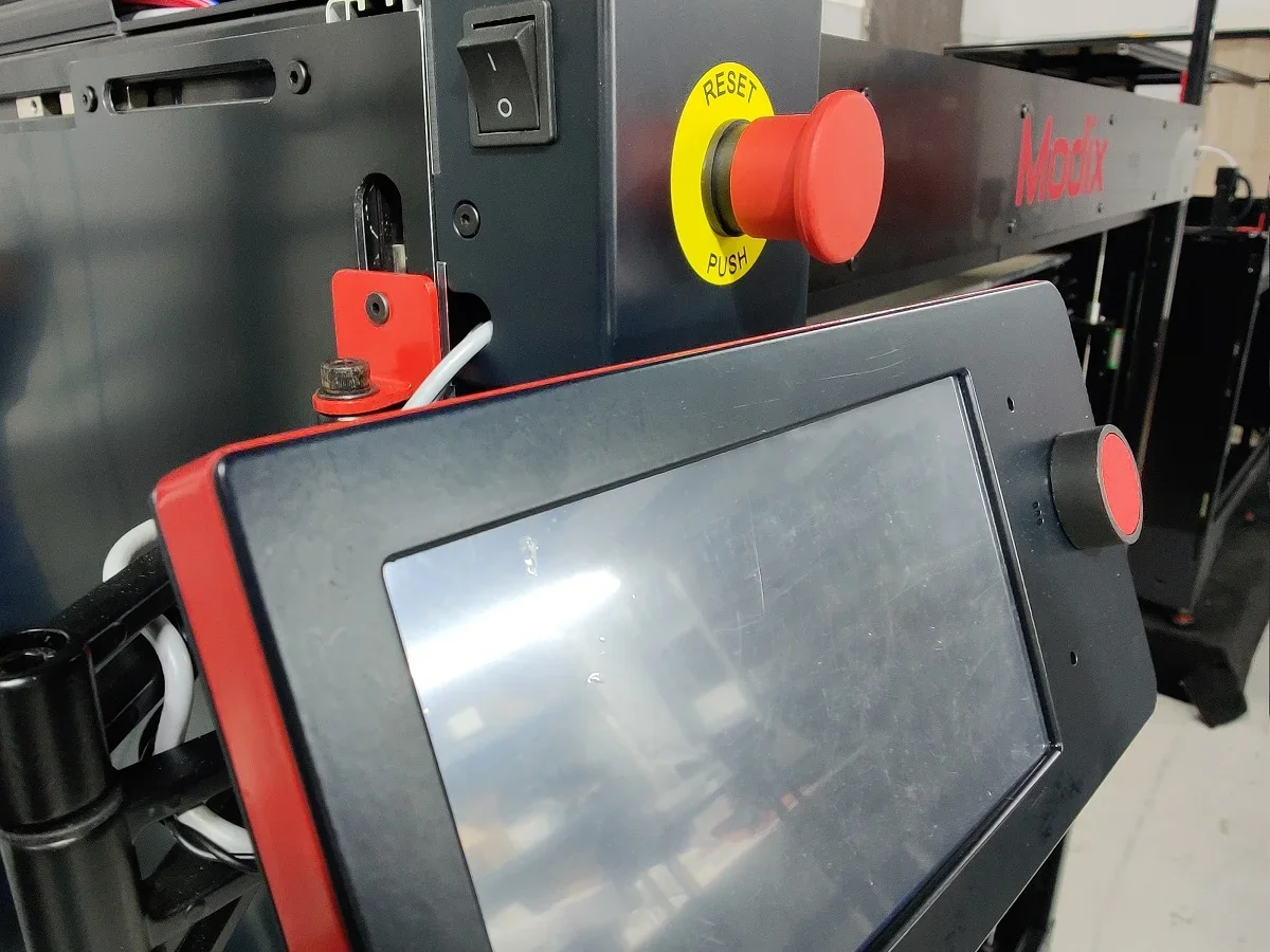 Modix Big Meter 3D printer control panel with red reset button and touchscreen interface, visible branding, designed for large-scale printing projects.