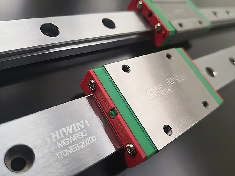 HIWIN linear rail components for Modix Everest 3D printer, featuring metallic surfaces and red-green accents, used for precision movement.