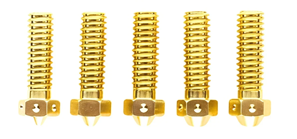 Gold Plated heat break parts for 3D printers, created with modix everest, displayed in a row on a white background.